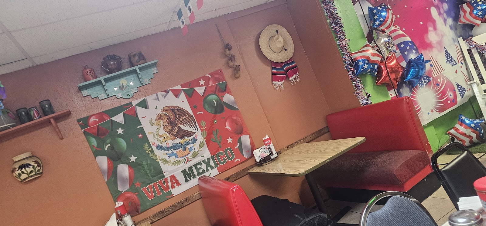 Festive dining booth decorated with a Viva Mexico banner